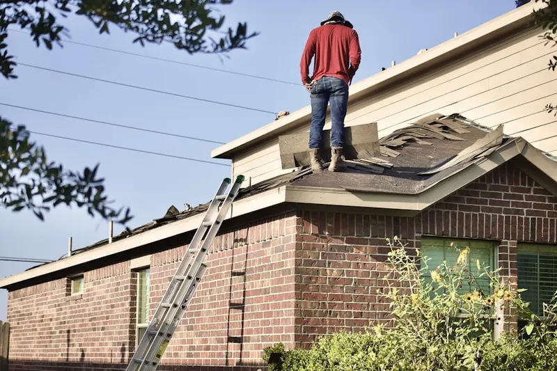Professional roofer working on a residential roof in Shady Valley